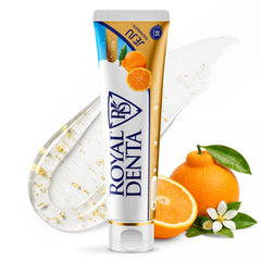 Tube of Royal Denta toothpaste with oranges and dental floss on a white background
