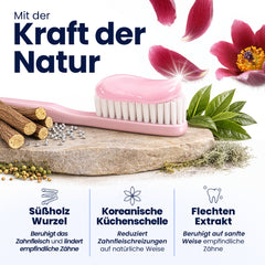Pink toothbrush with natural ingredients on a stone surface, surrounded by flowers and leaves, with text about natural power.